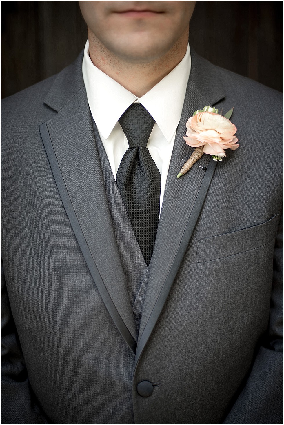 detail shot of grooms flower and tie