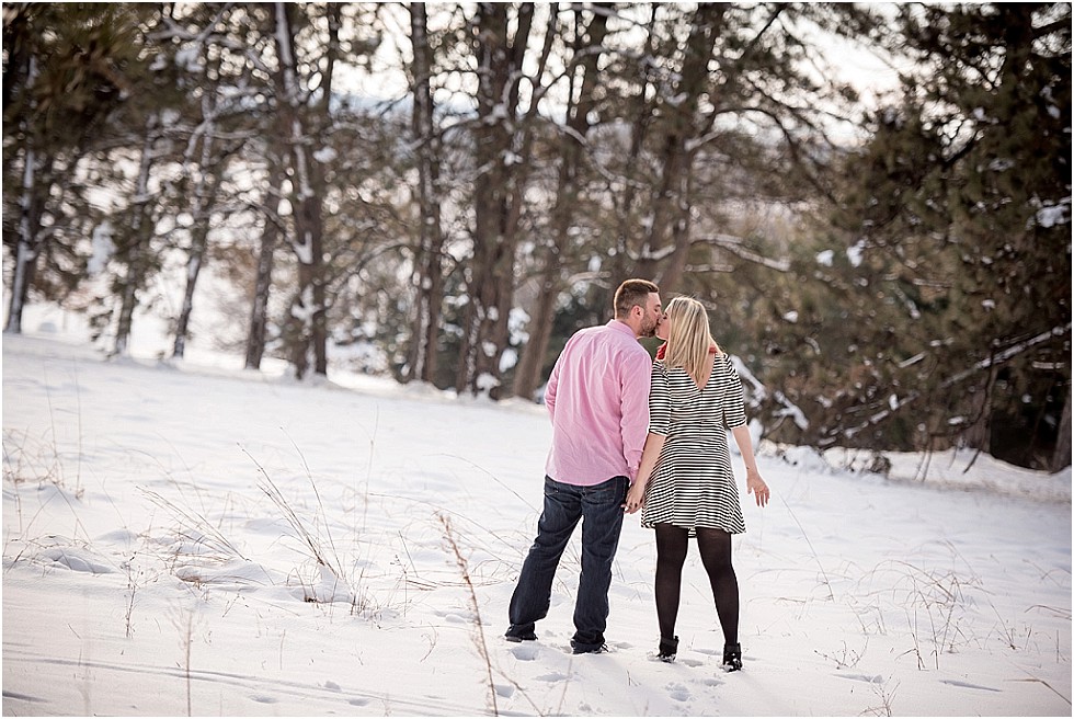 couple sharing a kiss in the snow Lincoln Nebraska engagement session
