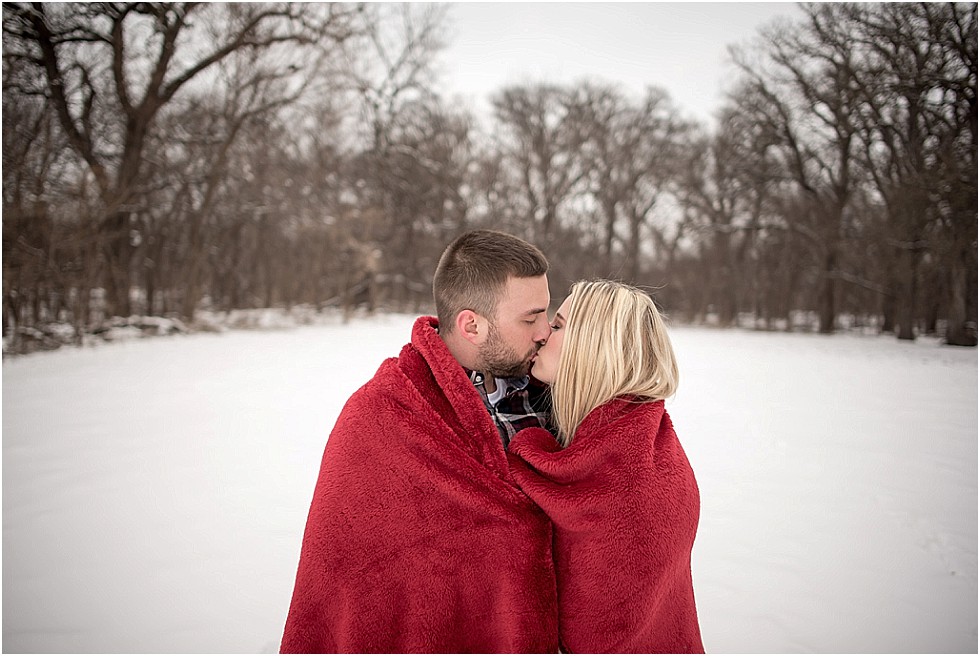 bride and groom wrapped in blanket kissing Lincoln Nebraska engagement photography
