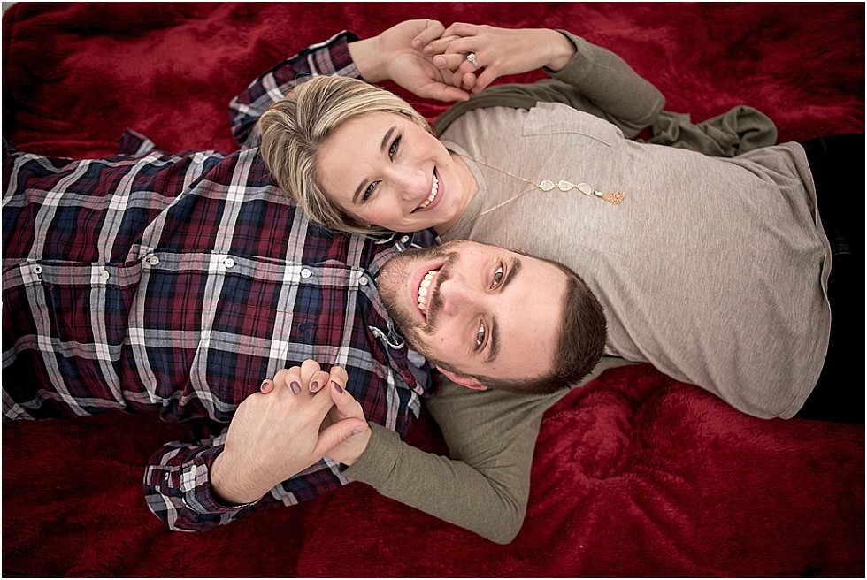 bride and groom laying on blanket Lincoln Nebraska engagement photography