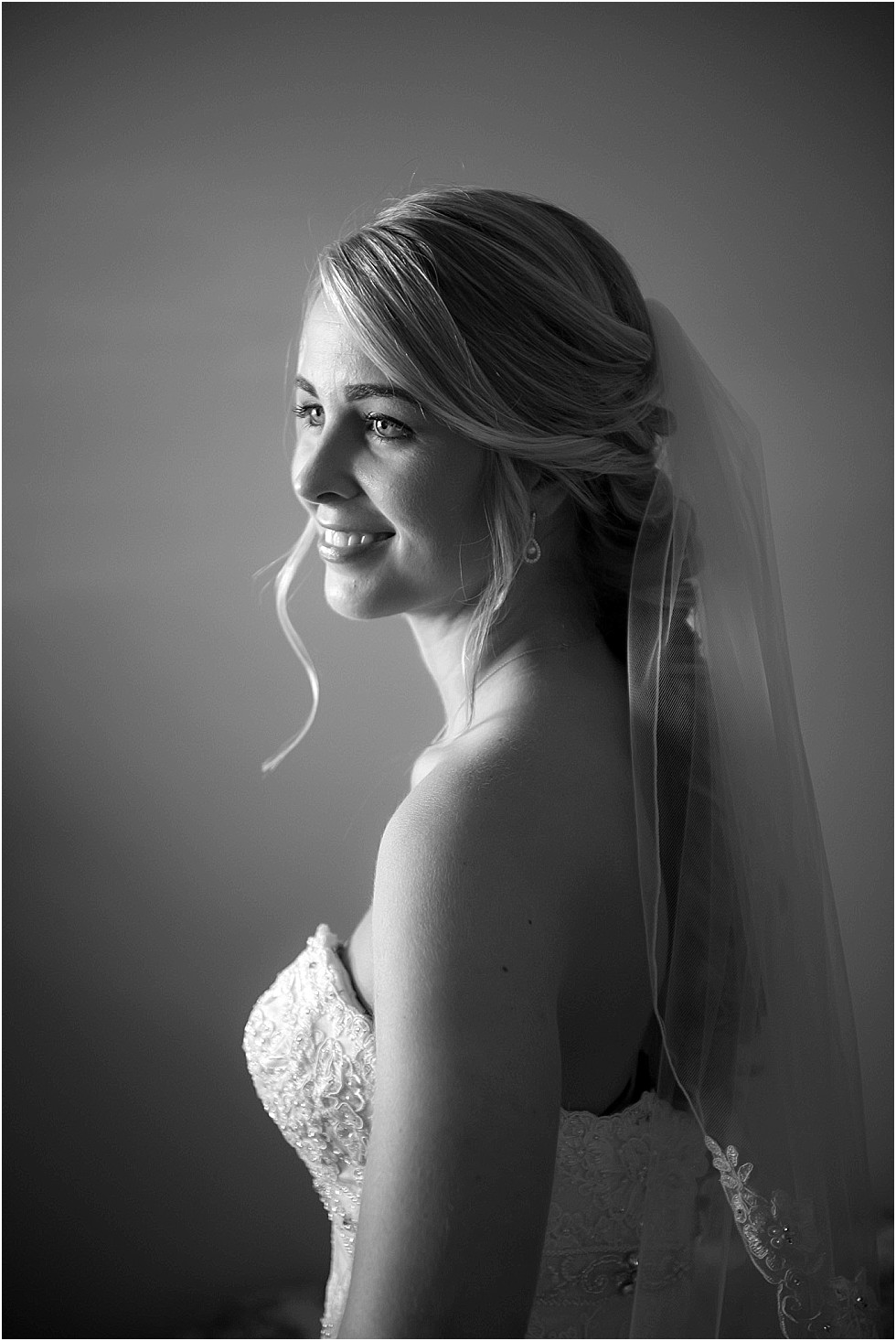 bride lit by window light black and white