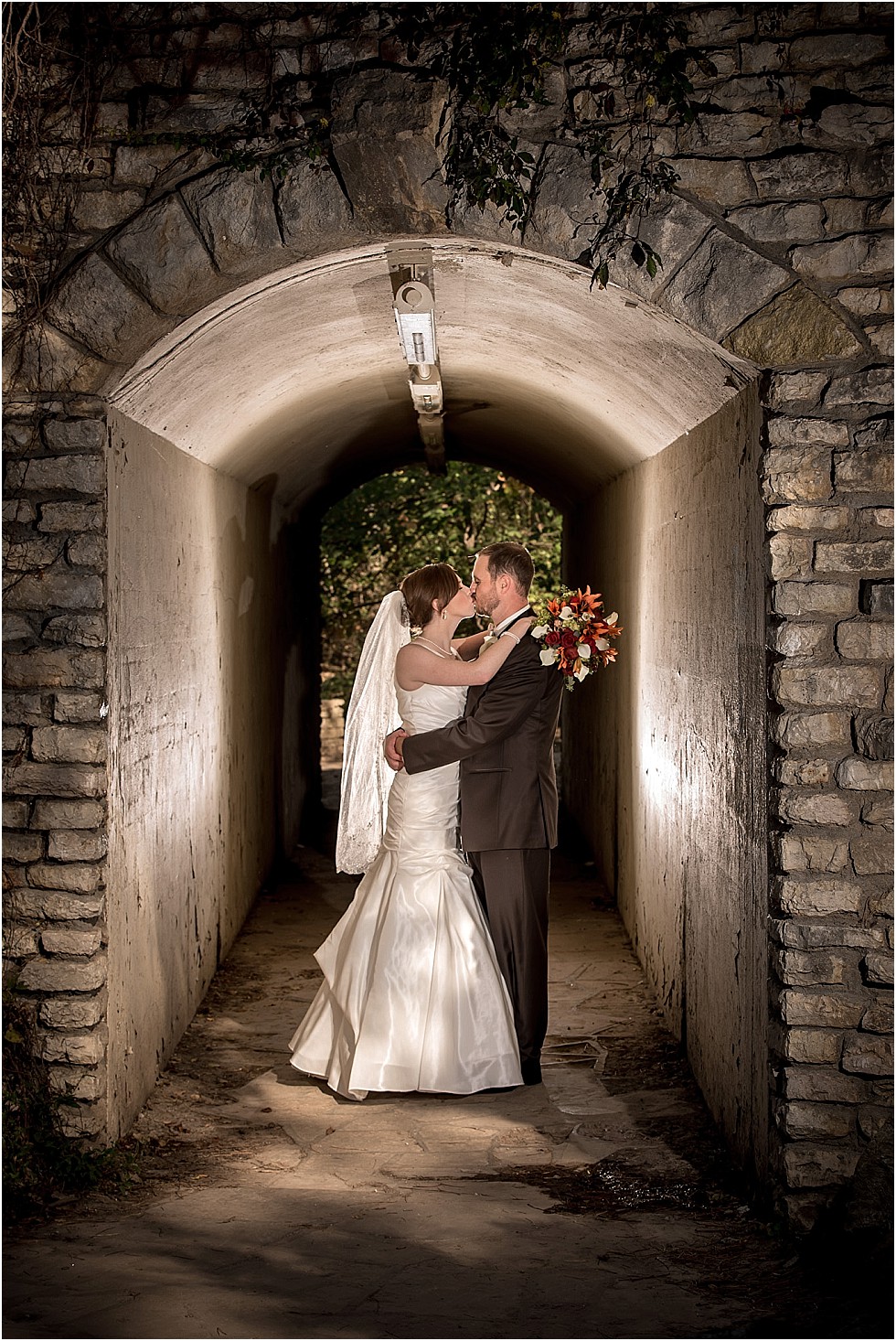 bride and groom kissing in tunnel in Elmwood Park Omaha Nebraska