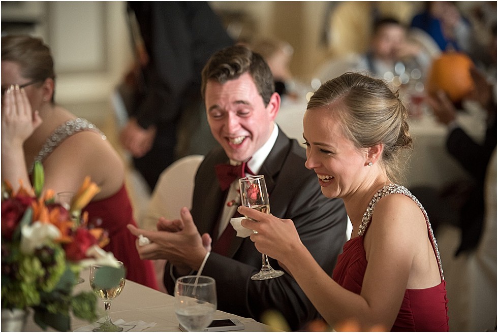 bridesmaid and groomsman laughing at toast at Livestock Exchange