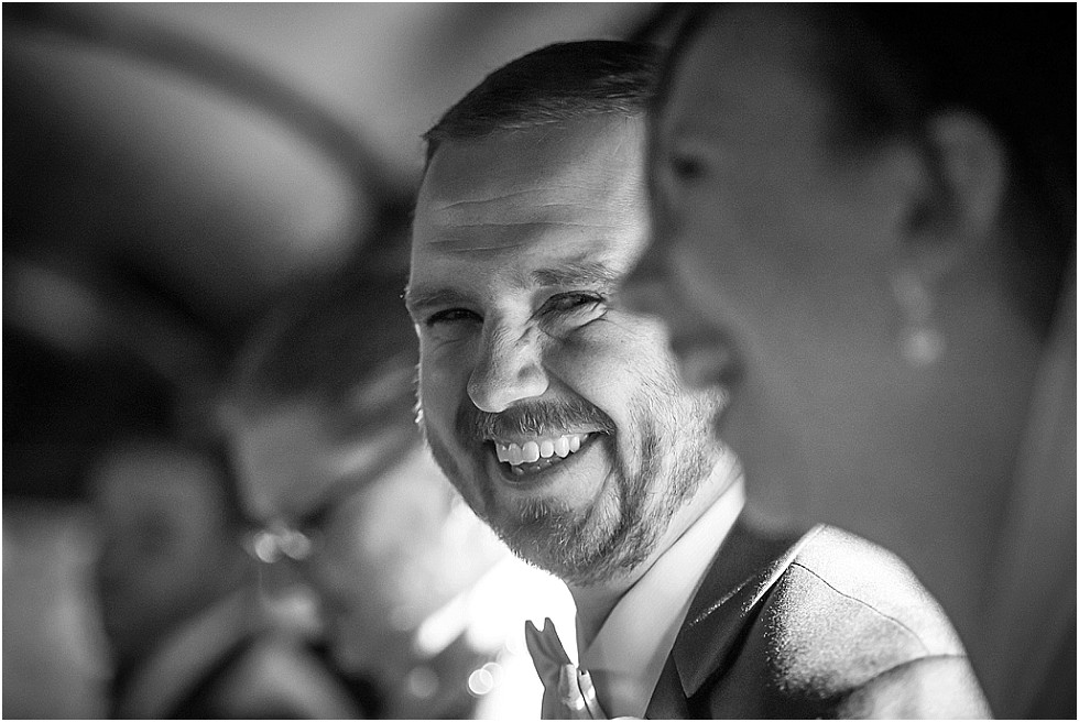 groom laughing on party bus Omaha Nebraska