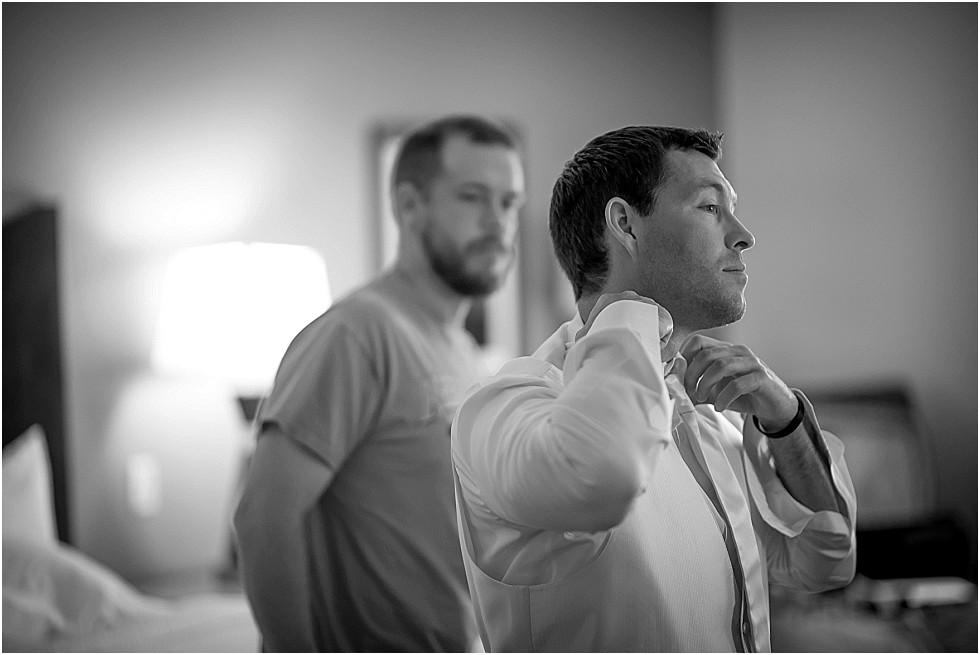 groom adjusting tie