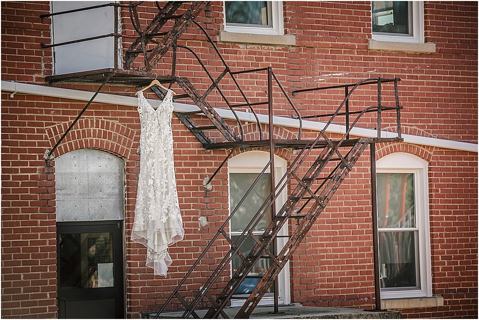 wedding dress hanging on stairs