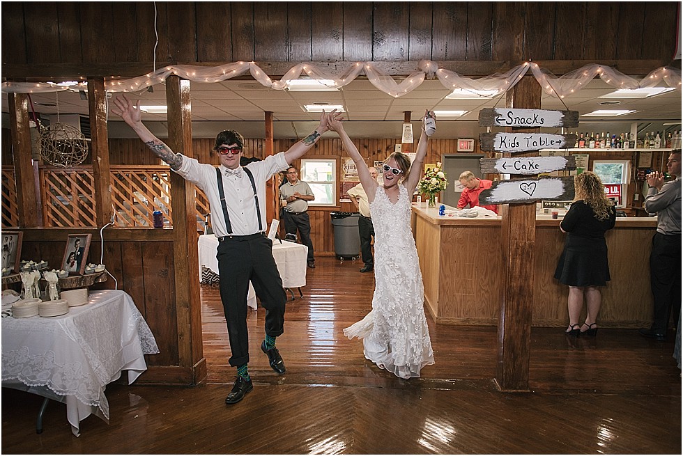 bride and groom celebrate when walking into reception