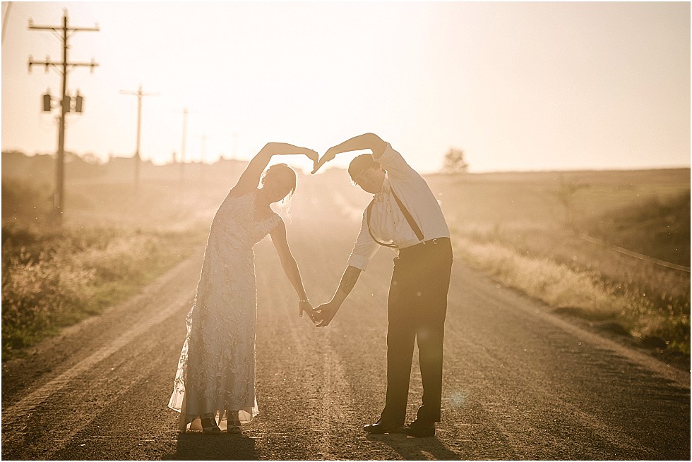 bride and groom making a heart shape with their arms