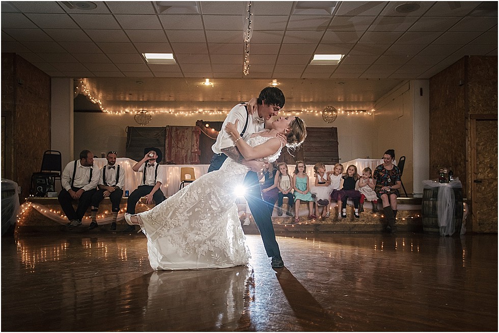 groom dips bride during first dance