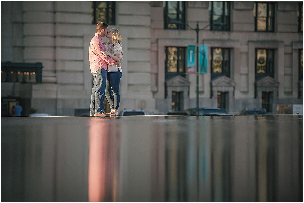 couple kissing on fountain in front of Union Station Kansas City