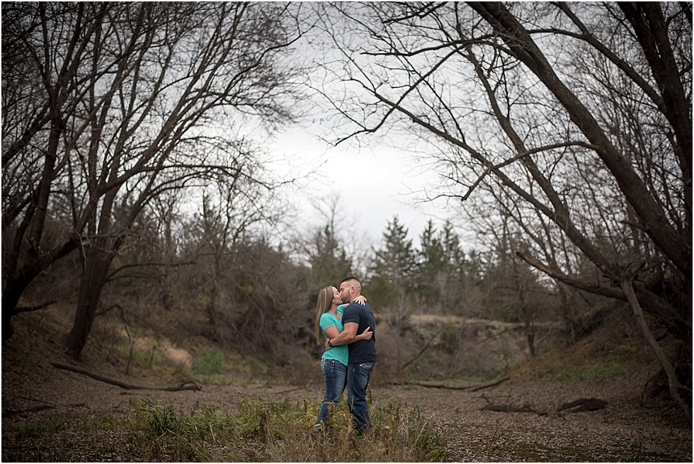 engagement photo kissing at Wilderness Park Lincoln Nebraska
