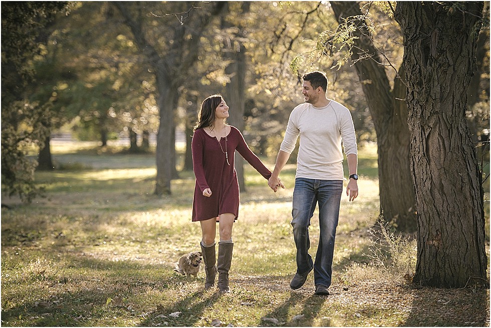 couple walking holding hands at fall engagement shoot