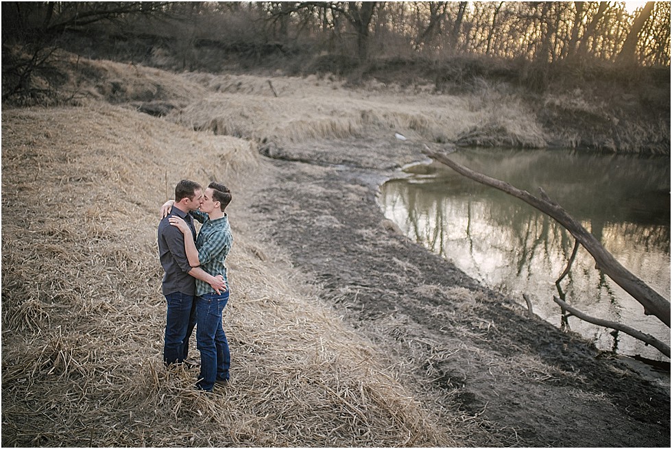 couple kiss by creek