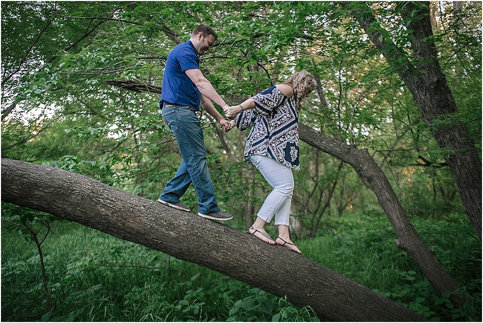 couple climbing down tree