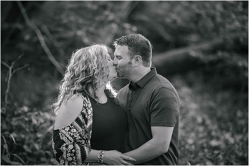 black and white photo of couple kissing on engagement shoot