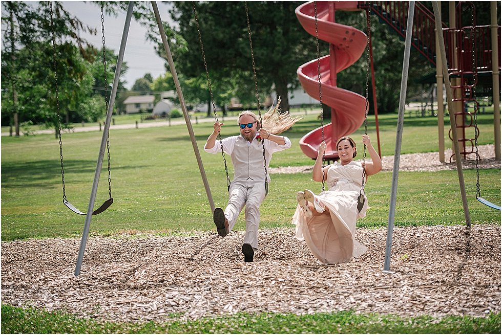 bride and groom on swing set