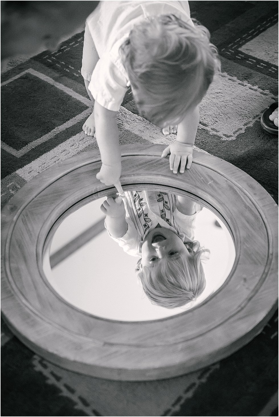 toddler looking at reflection in mirror