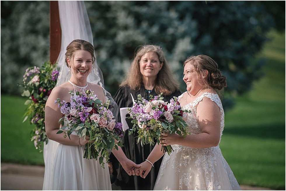 brides smiling during ceremony