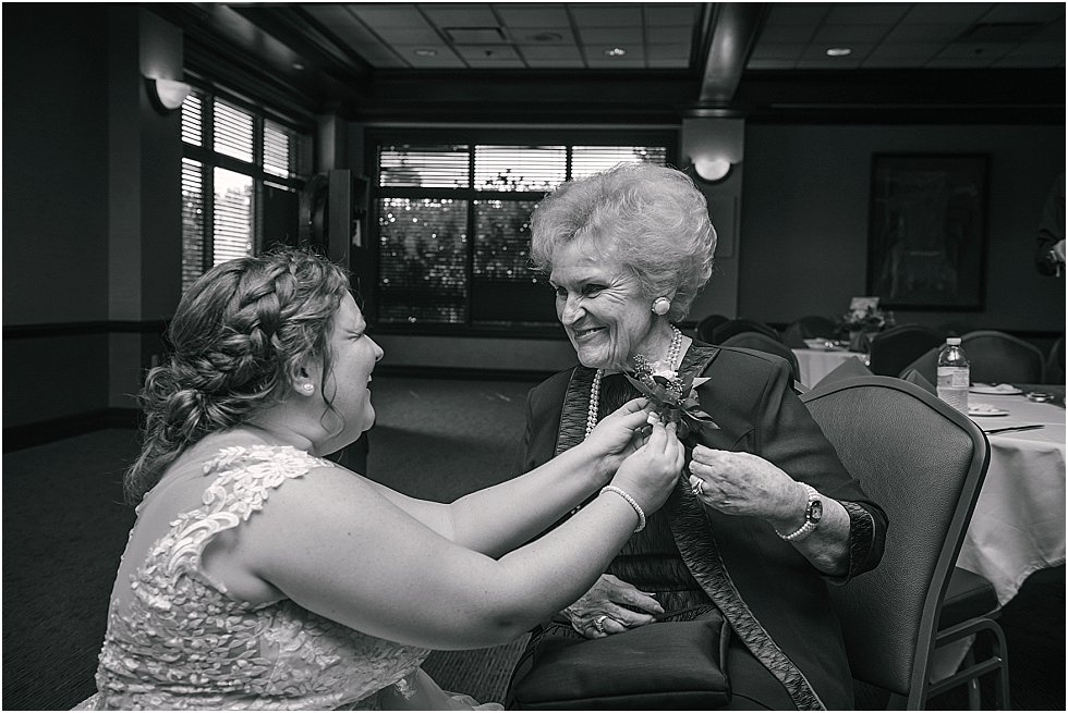 bride pinning grandmother