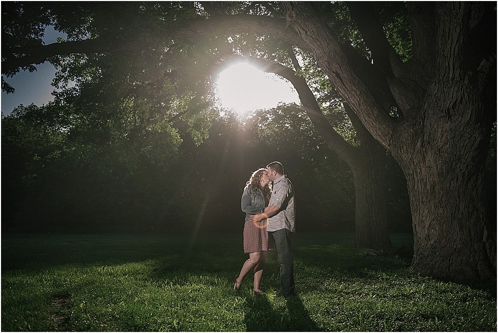 couple kissing under trees in wilderness park lincoln nebraska